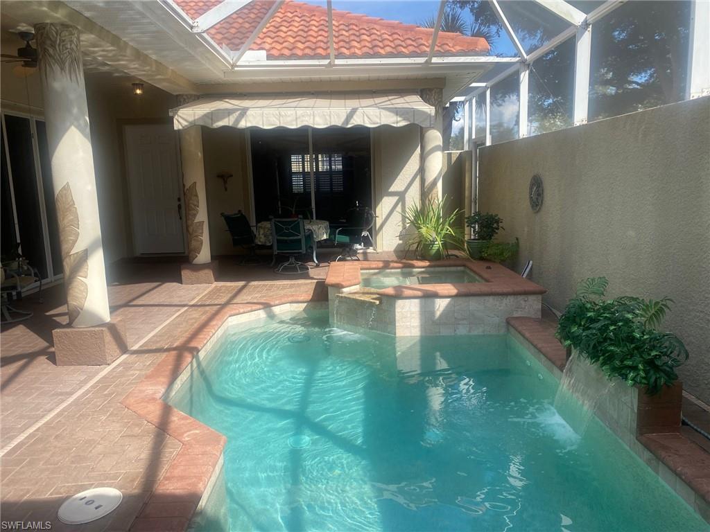 Relaxing pool and spa looking toward seating area and main house entry