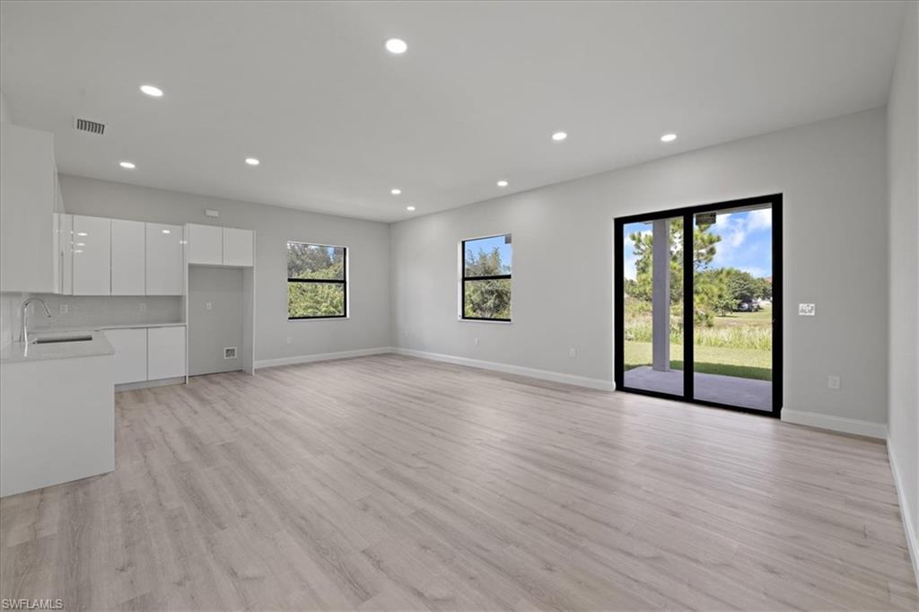 Unfurnished living room featuring recessed lighting and light wood-style flooring