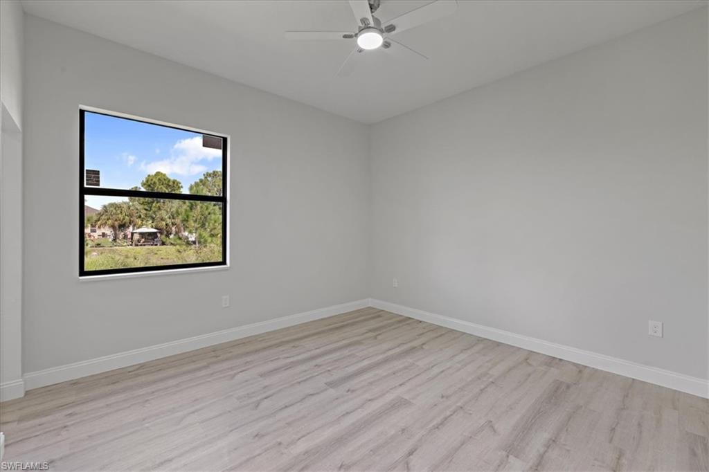 Spare room featuring light wood-style flooring and a ceiling fan