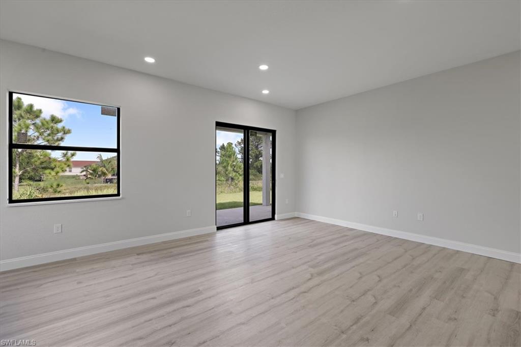Spare room with light wood-style floors and recessed lighting
