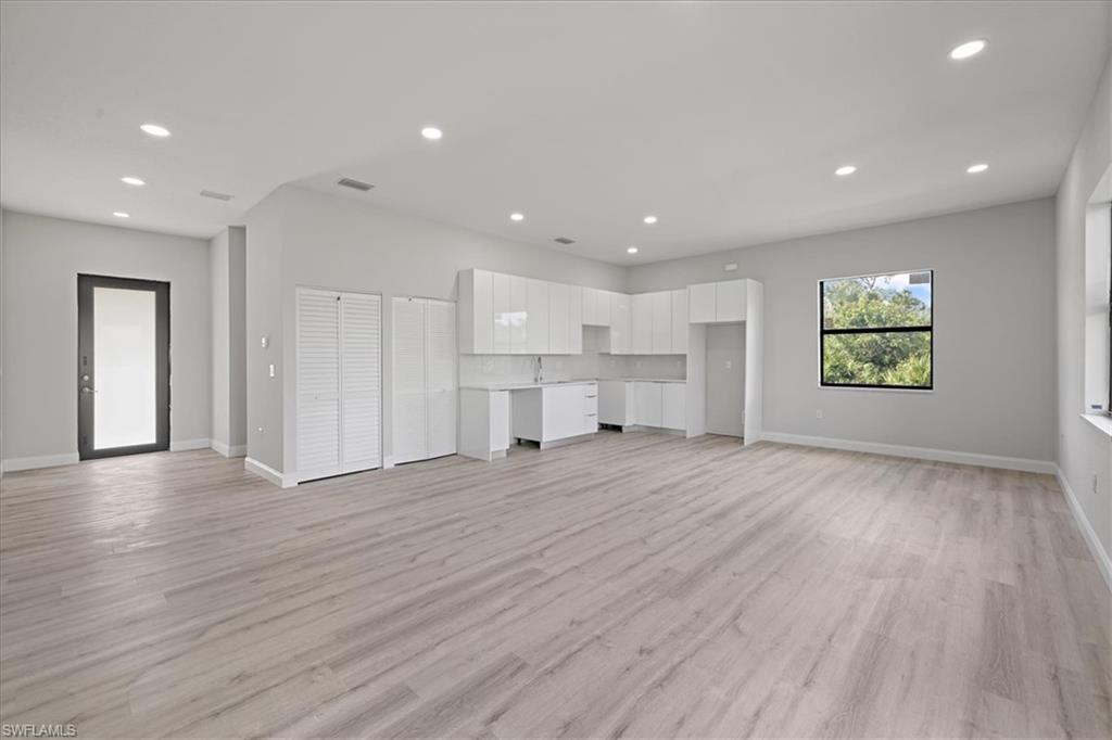Unfurnished living room with light wood-style flooring and recessed lighting