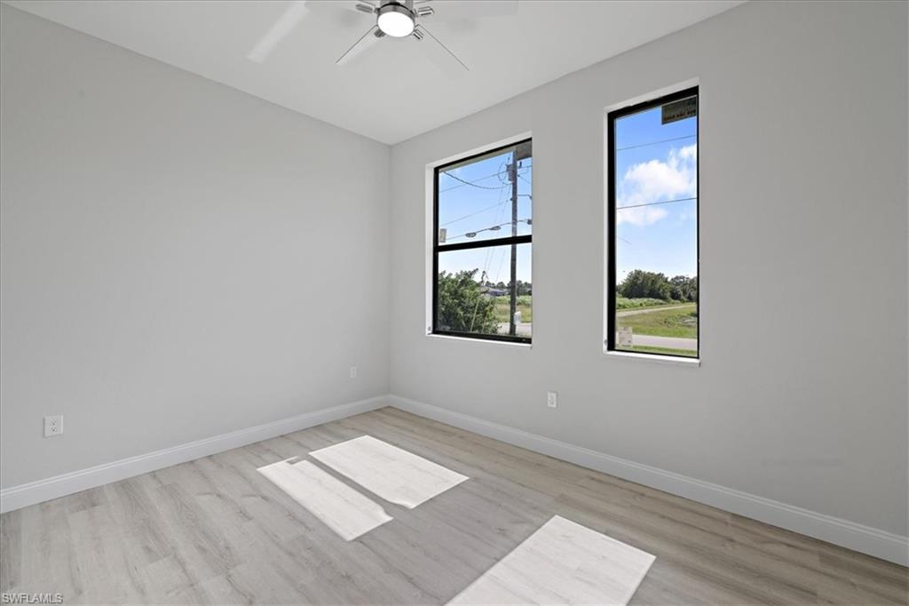 Unfurnished room with light wood-style floors and a ceiling fan