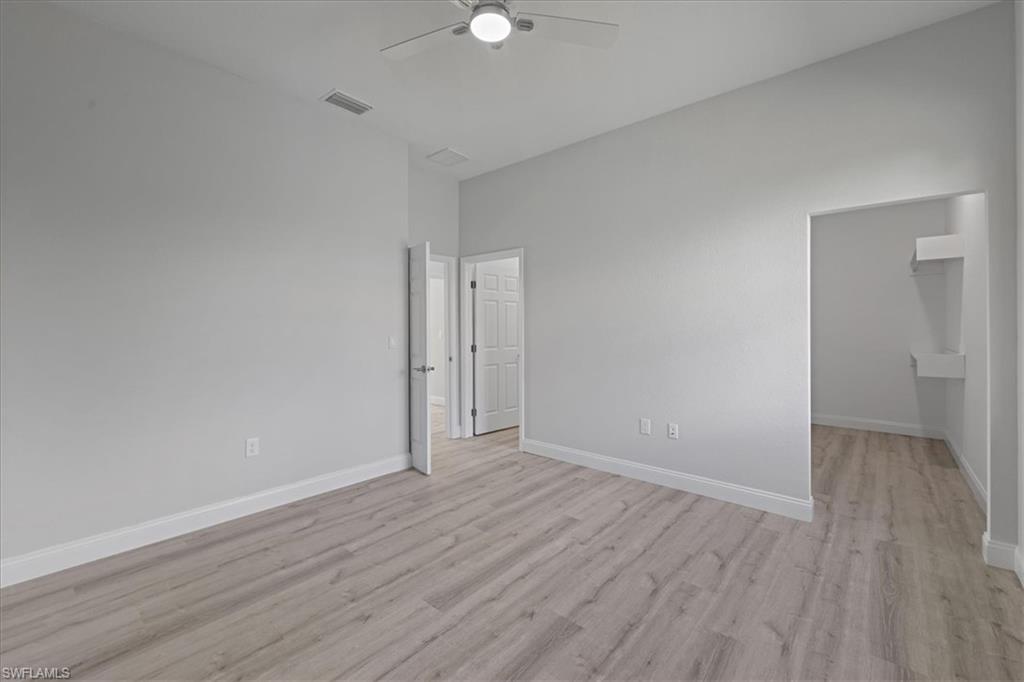 Spare room featuring light wood-type flooring and a ceiling fan