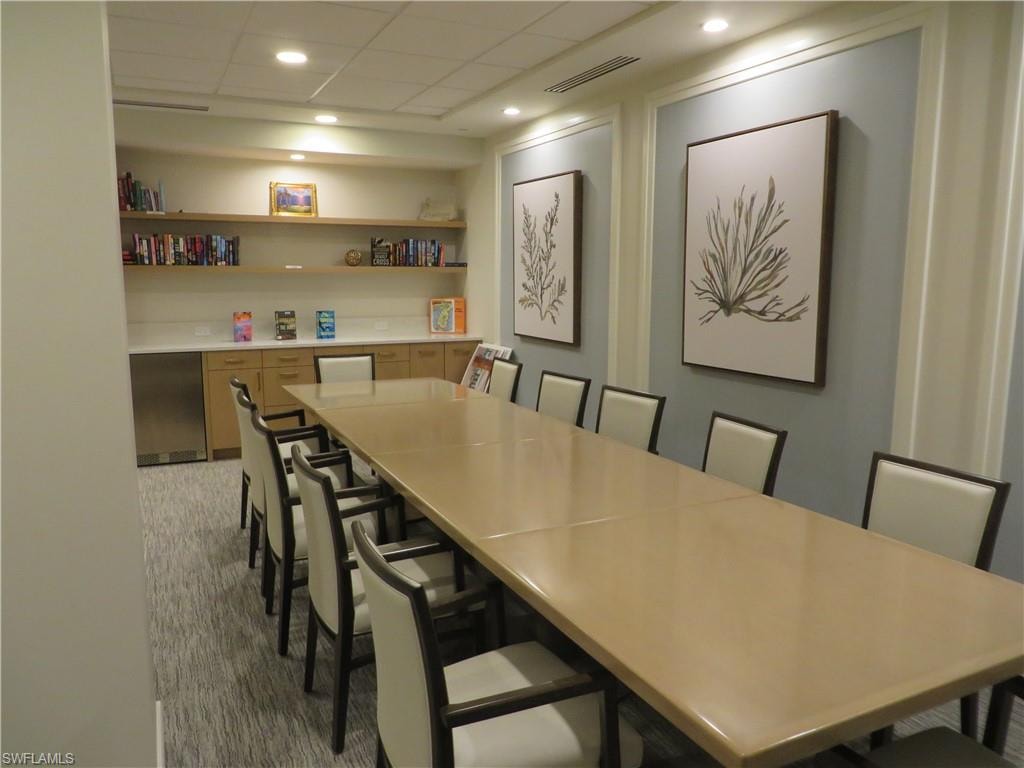 Dining space with a paneled ceiling and recessed lighting
