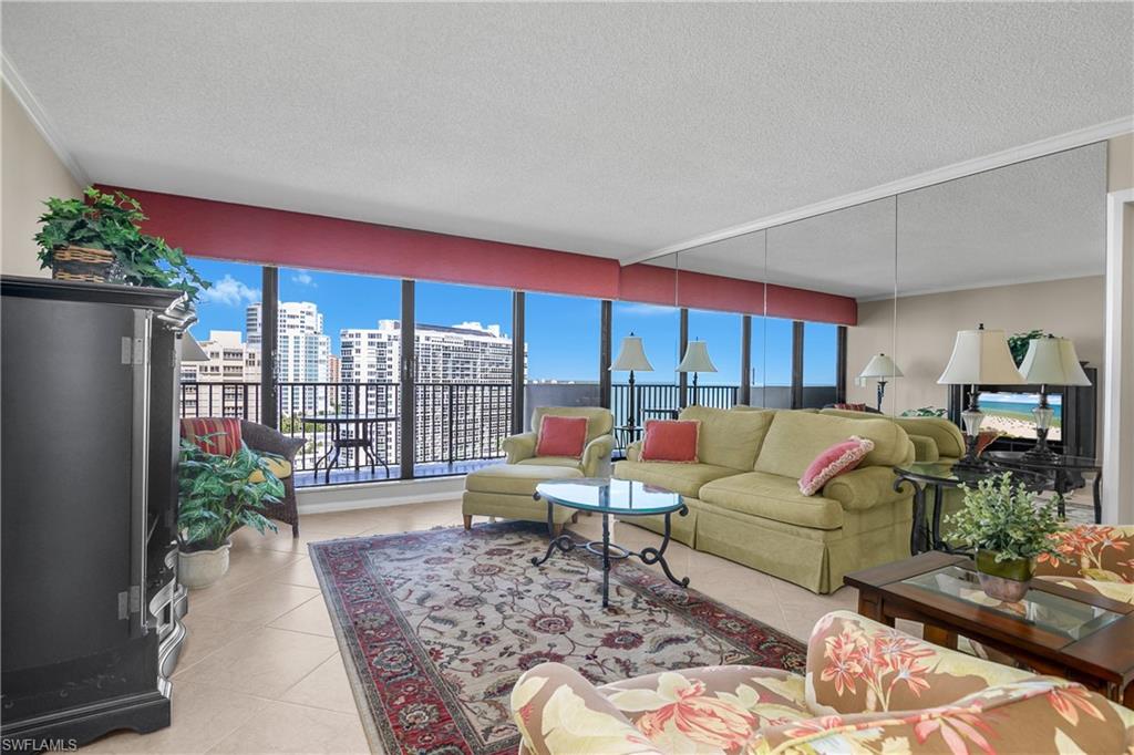 Living room featuring light tile patterned floors, a textured ceiling, and a view of city