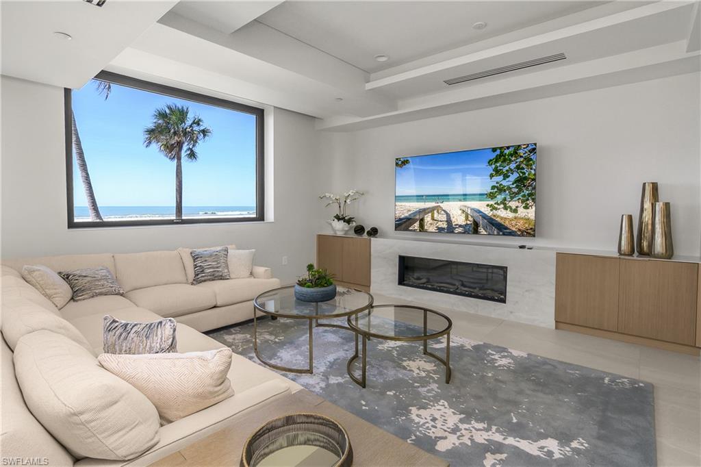 Tiles Social Room seating with large screen tv, fireplace and great Gulf views