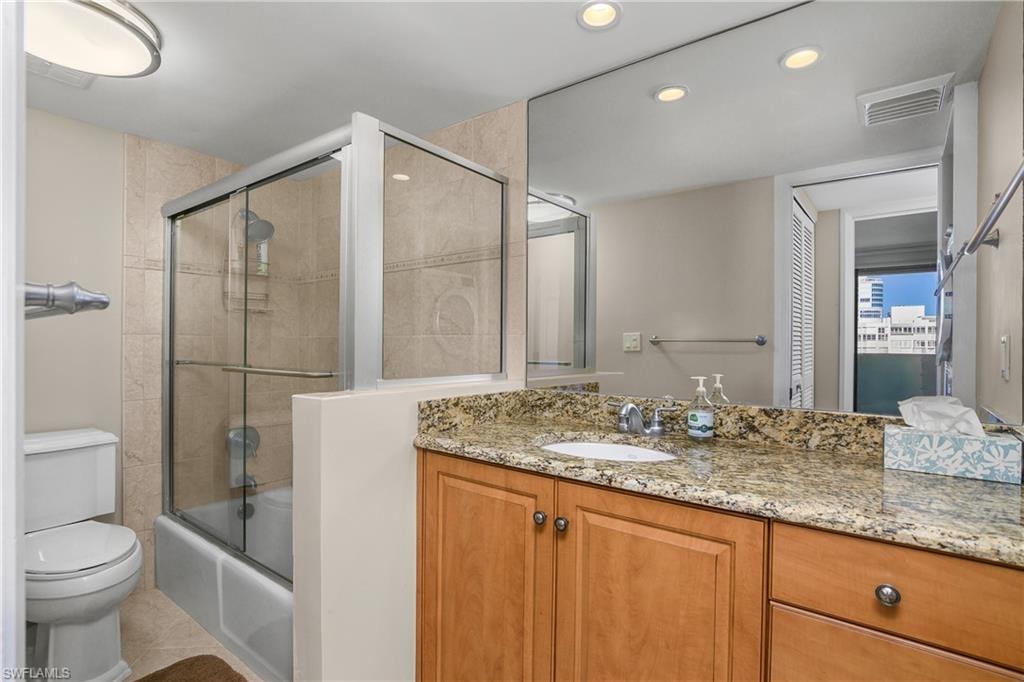 Full bathroom with vanity, shower / bath combination with glass door, recessed lighting, and tile patterned floors