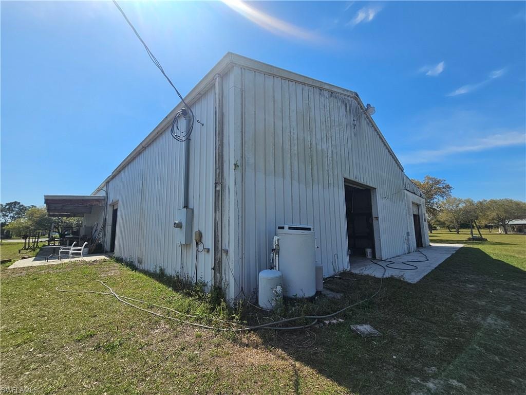 View of pole building with a lawn