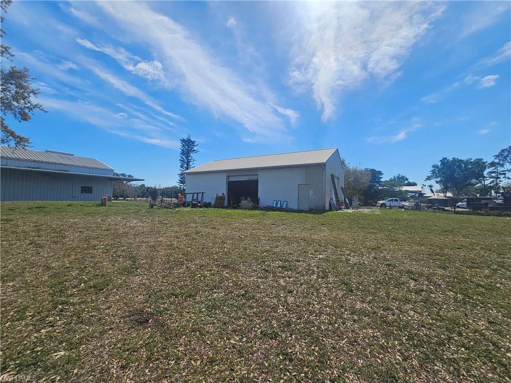 View of yard featuring an outbuilding and a pole building