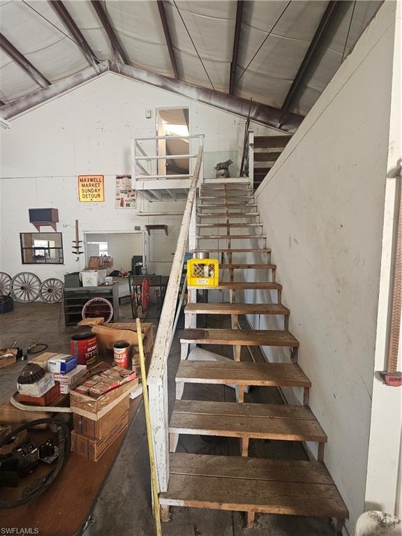 Stairs featuring vaulted ceiling