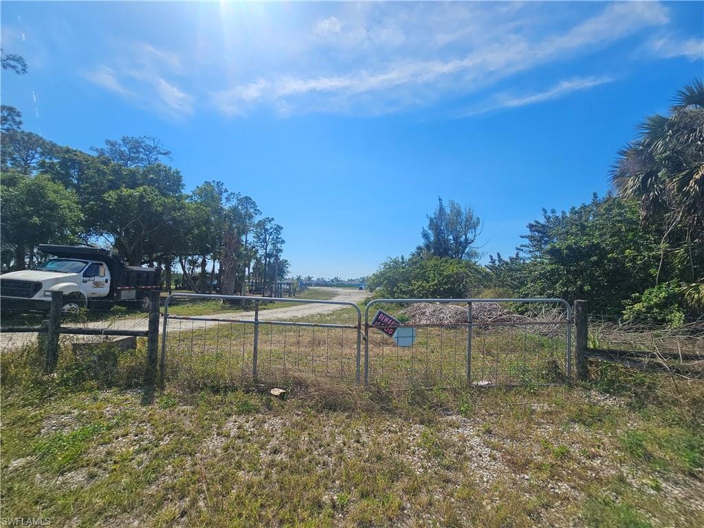 View of yard featuring a rural view and fence. Back private entrance.