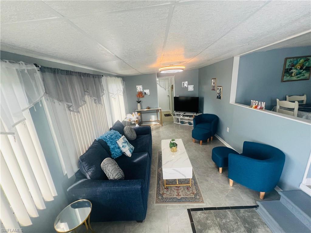 Living room with baseboards and tile patterned floors