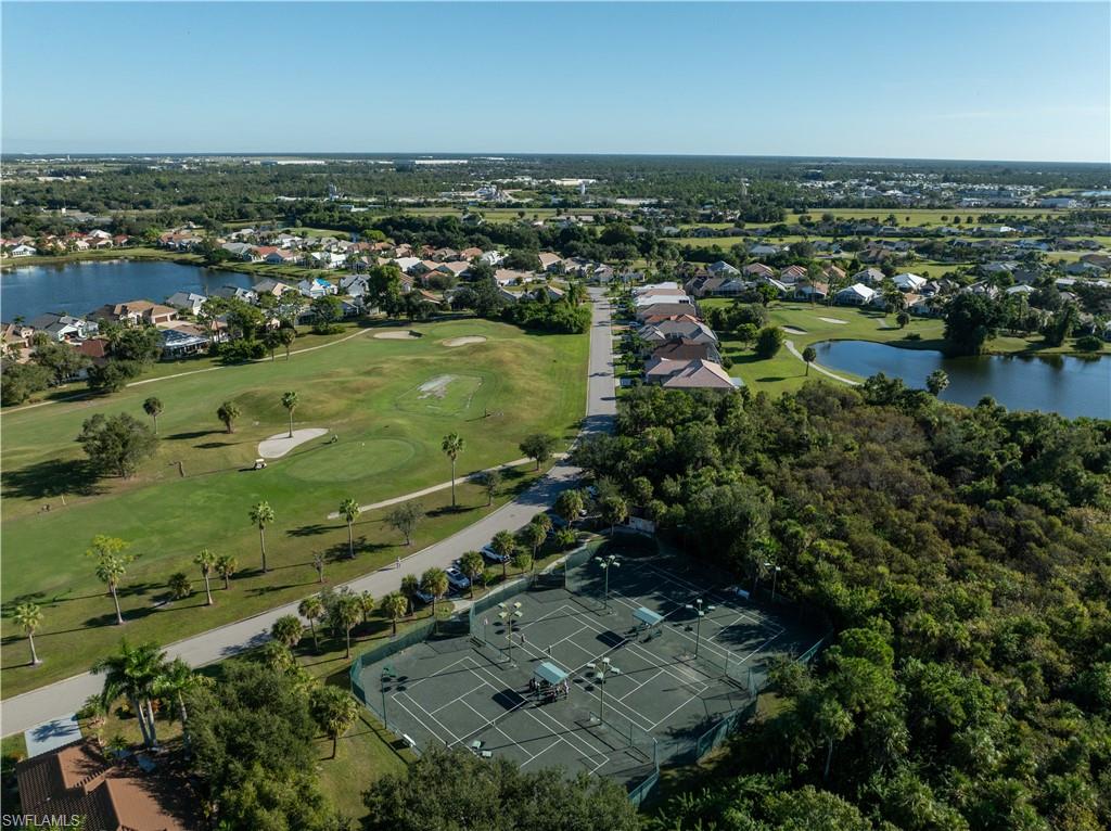 Aerial view of property and surrounding area with a nearby body of water and nearby suburban area