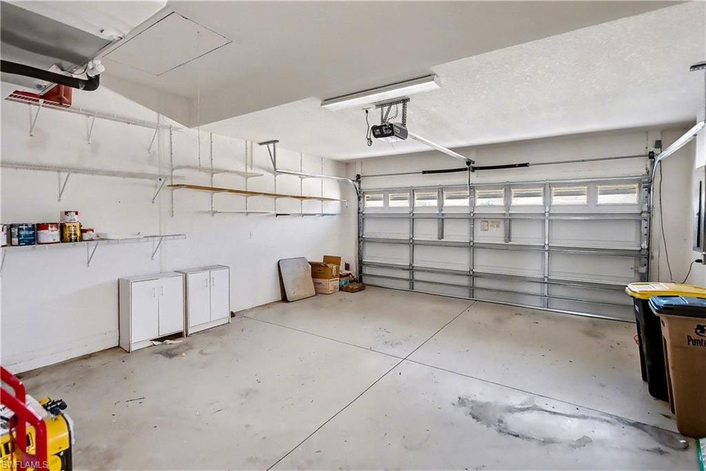 Garage featuring a garage door opener
