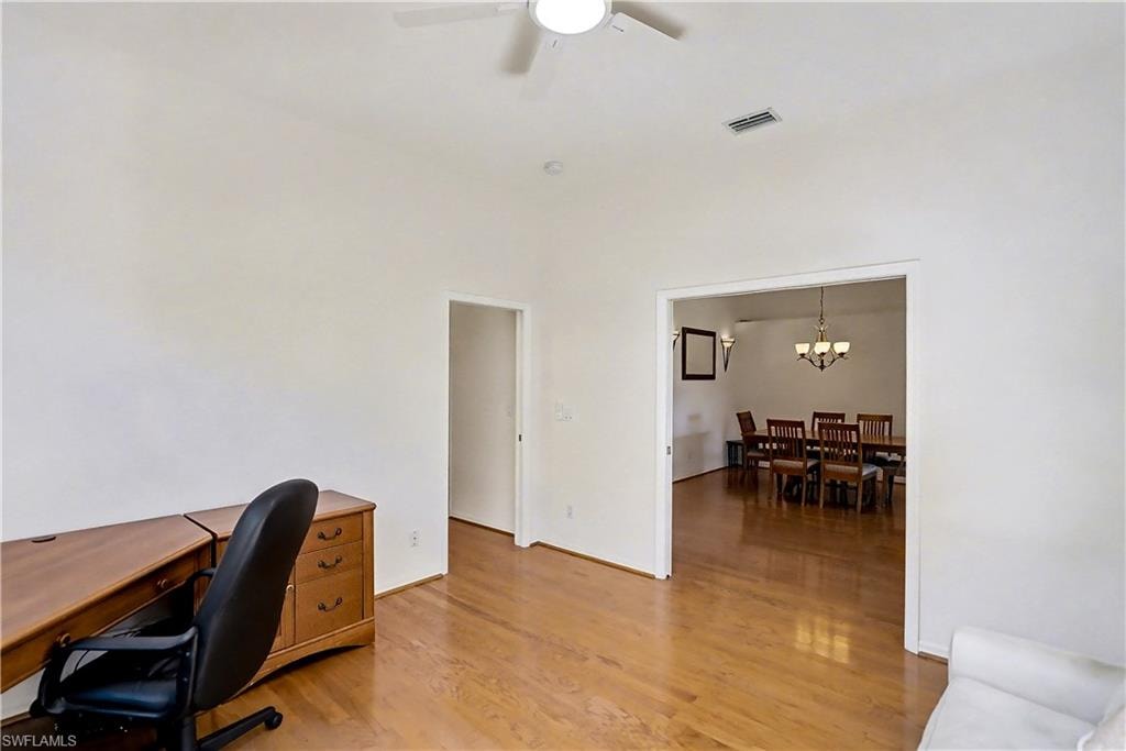 Home office with light wood finished floors