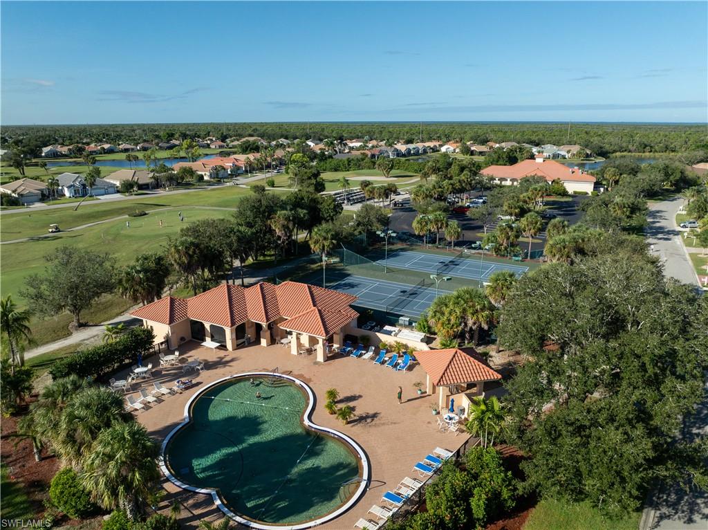 Aerial view of residential area with a local golf course and a nearby body of water