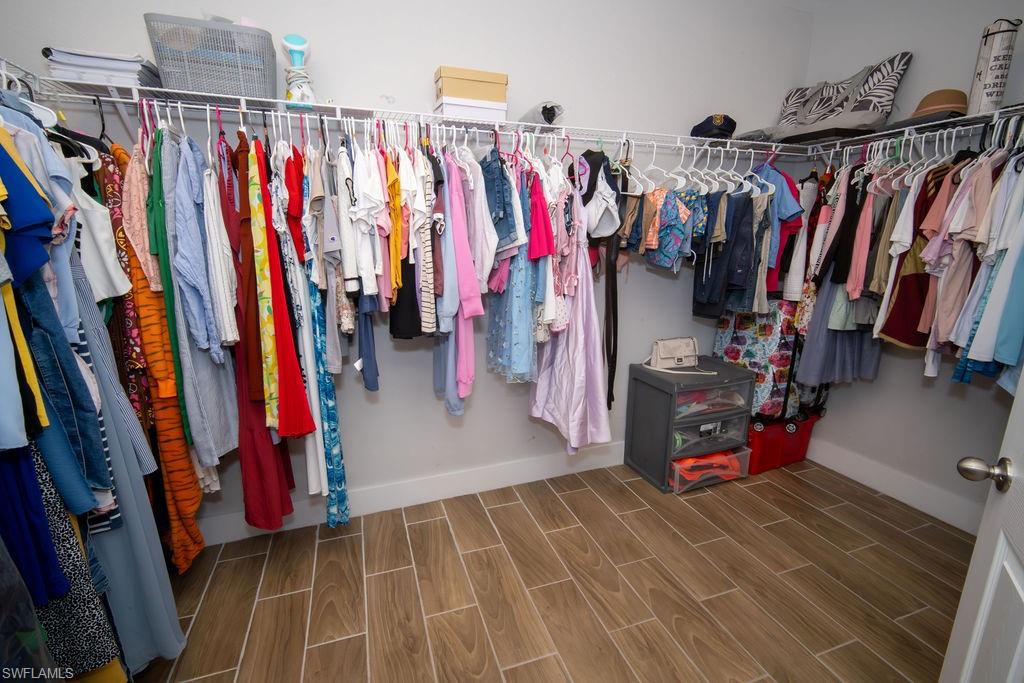 Spacious closet with wood tiled floors