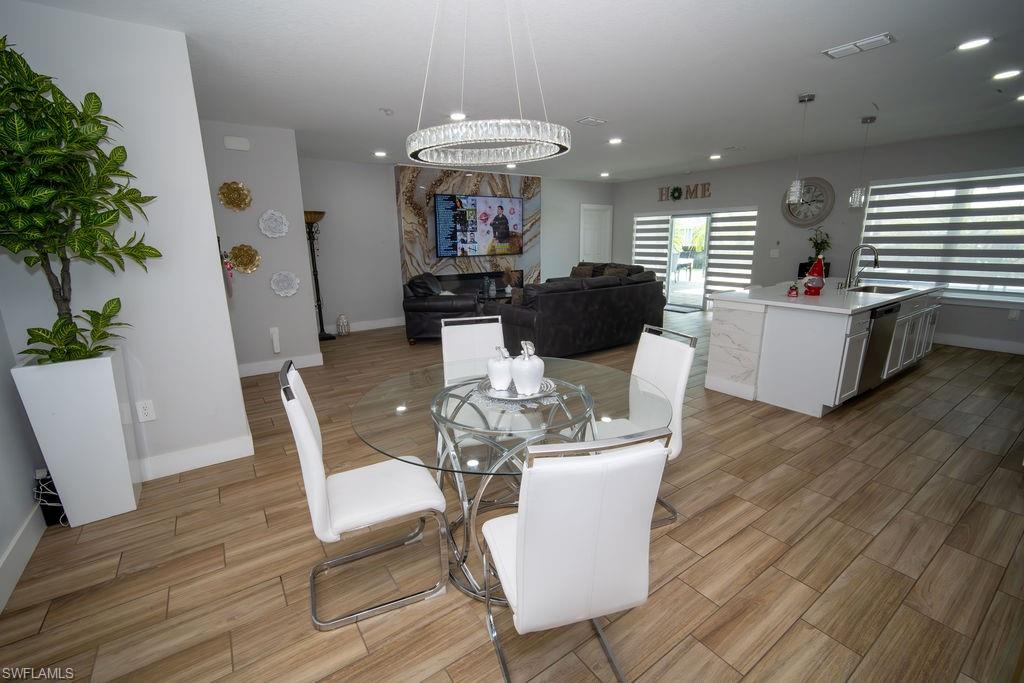 Dining area featuring wood finish floors and recessed lighting
