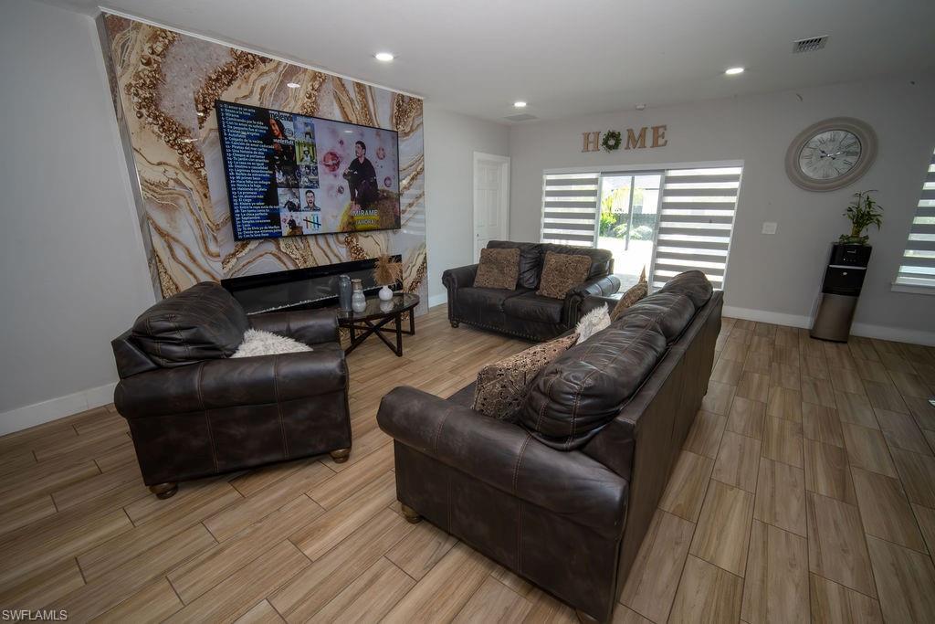 Living room with wood finish floors and recessed lighting