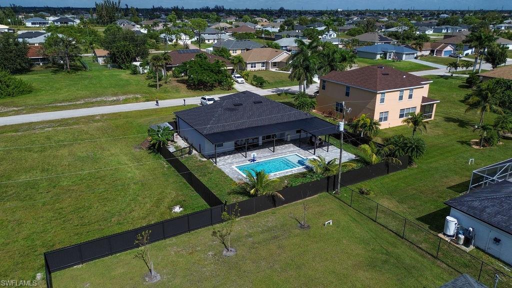 Aerial view of residential area featuring a pool area