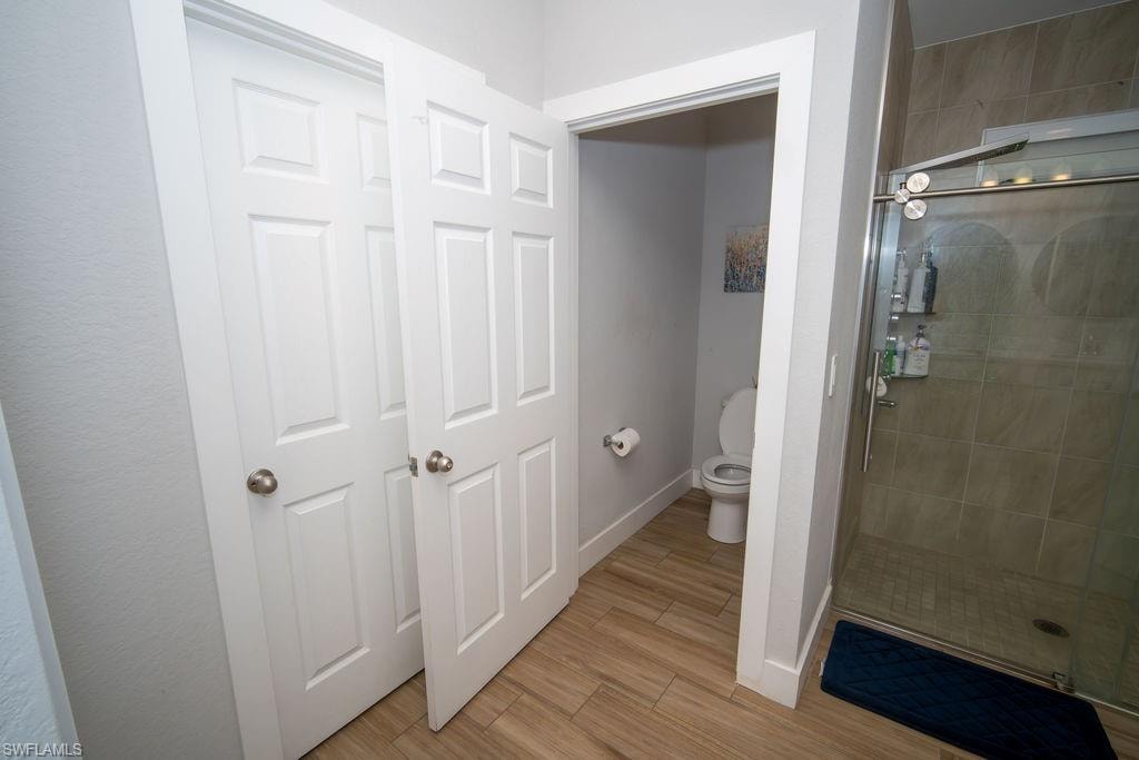 Bathroom with light wood-style flooring and a stall shower