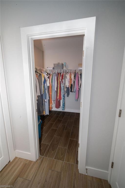 Spacious closet with wood finish floors