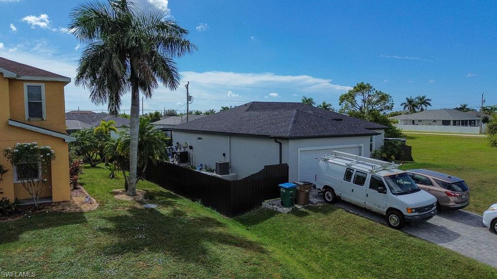 View of property exterior featuring stucco siding and driveway