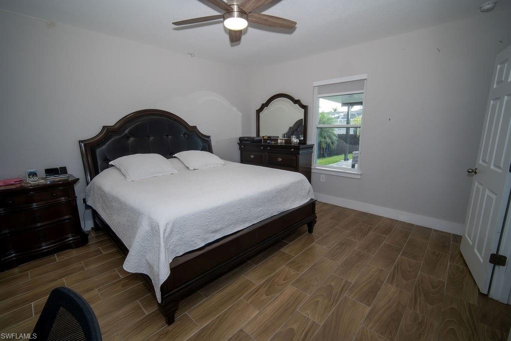 Bedroom featuring wood tiled floors and a ceiling fan