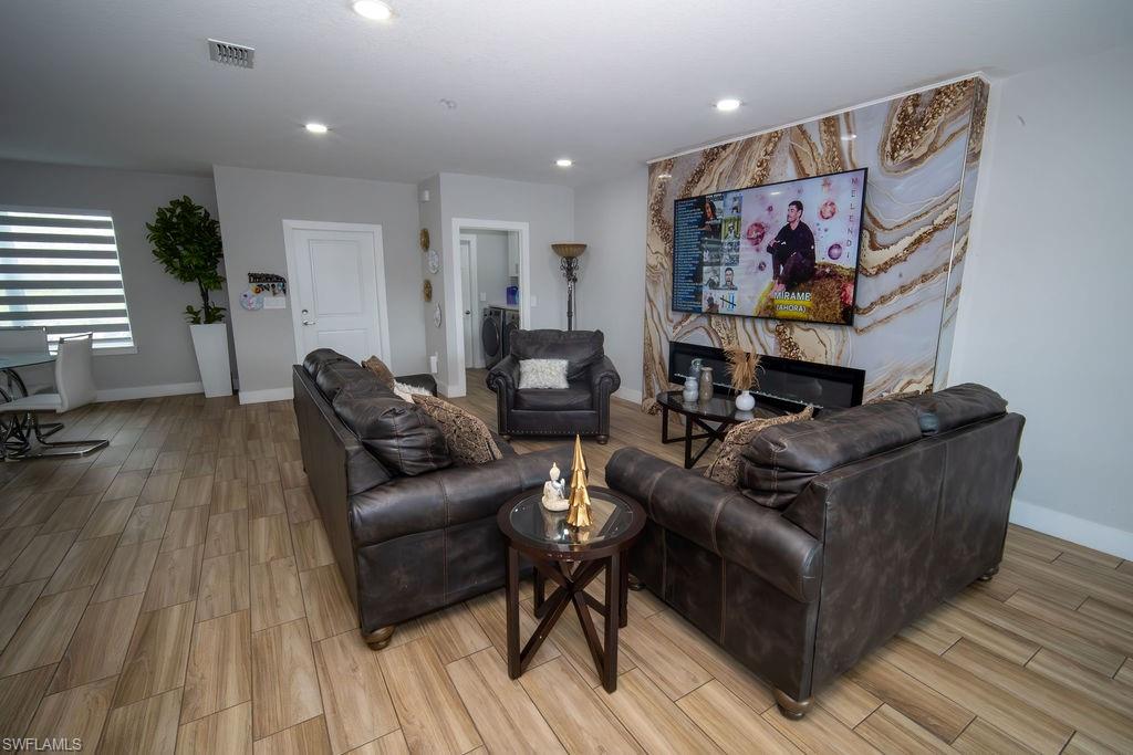 Living room with wood finish floors and recessed lighting