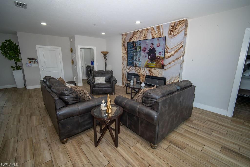 Living area with wood tiled floors and recessed lighting