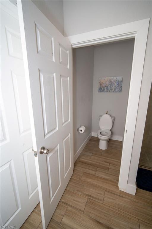 Bathroom with toilet and light wood-style flooring
