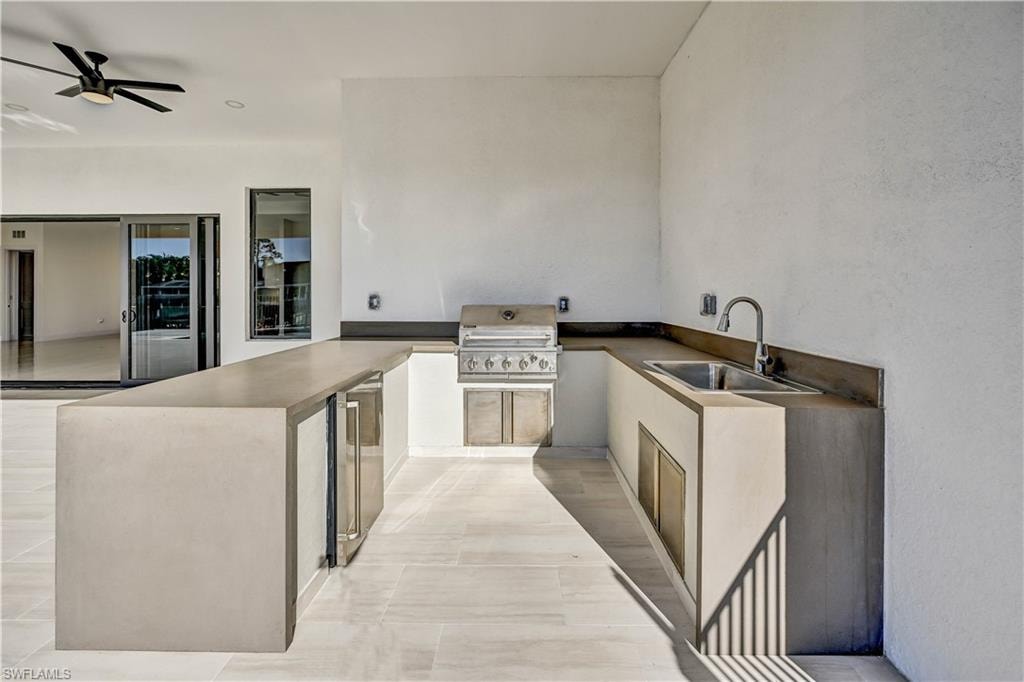 View of patio / terrace featuring an outdoor kitchen and a ceiling fan
