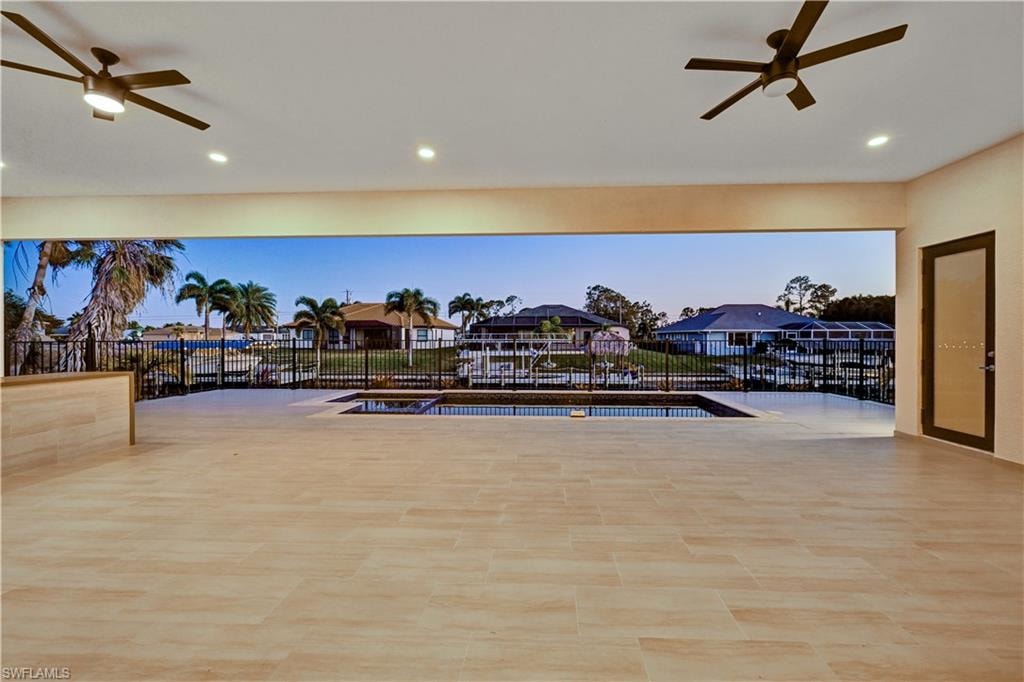 View of swimming pool featuring ceiling fan