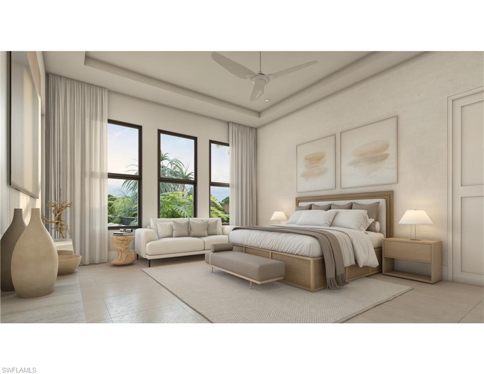 Bedroom with a tray ceiling and ceiling fan