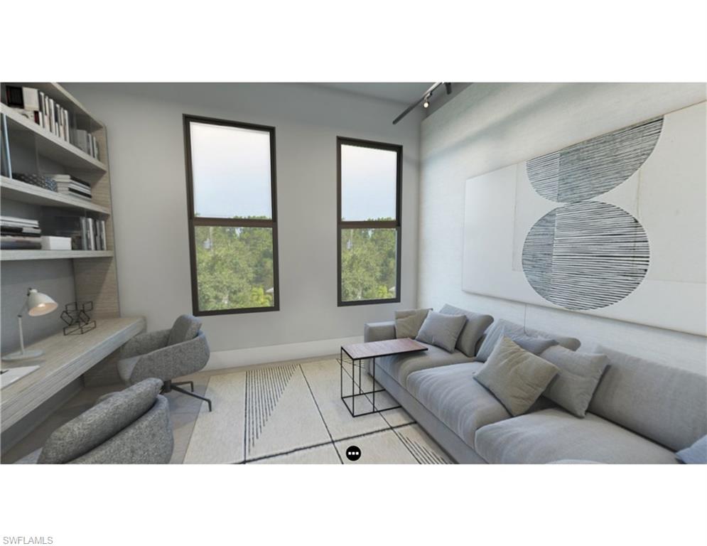 Living room featuring rail lighting and baseboards