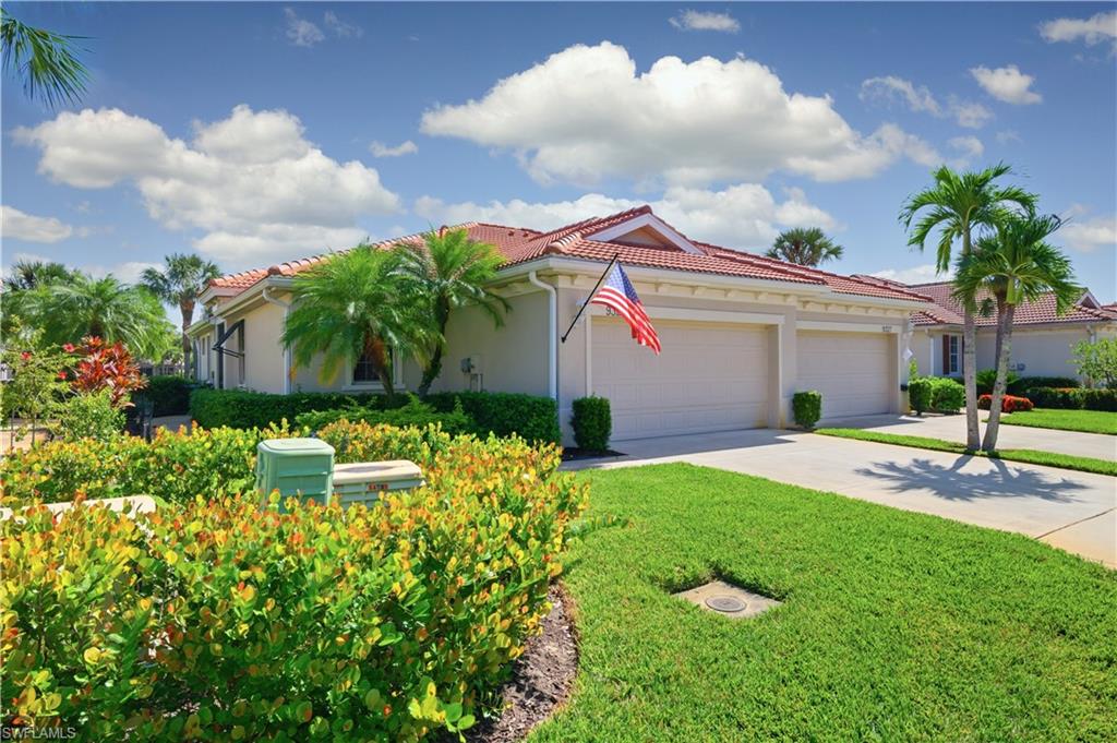 Mediterranean / spanish-style home featuring stucco siding, driveway, a tiled roof, a garage, and a front yard