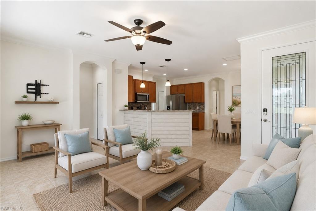 AI generated Open-concept living space featuring neutral tile flooring, a dark wood-finish ceiling fan, and crown molding