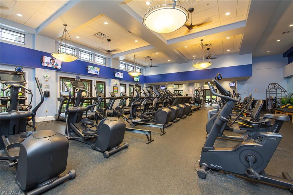 Workout area with recessed lighting and a towering ceiling