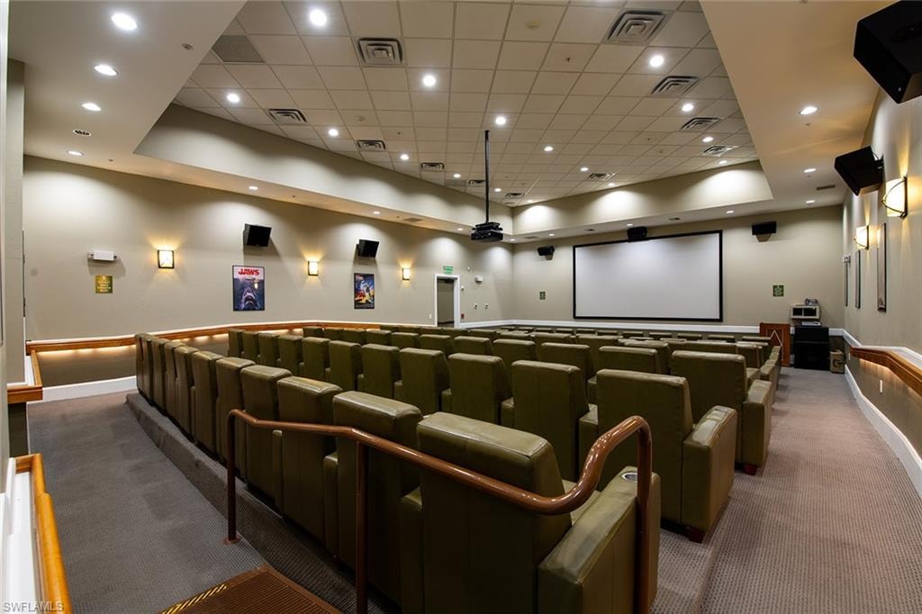 Carpeted cinema room featuring recessed lighting, a tray ceiling, and a drop ceiling