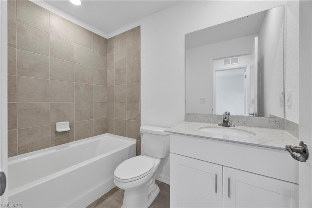 Bathroom featuring vanity and shower / bathtub combination
