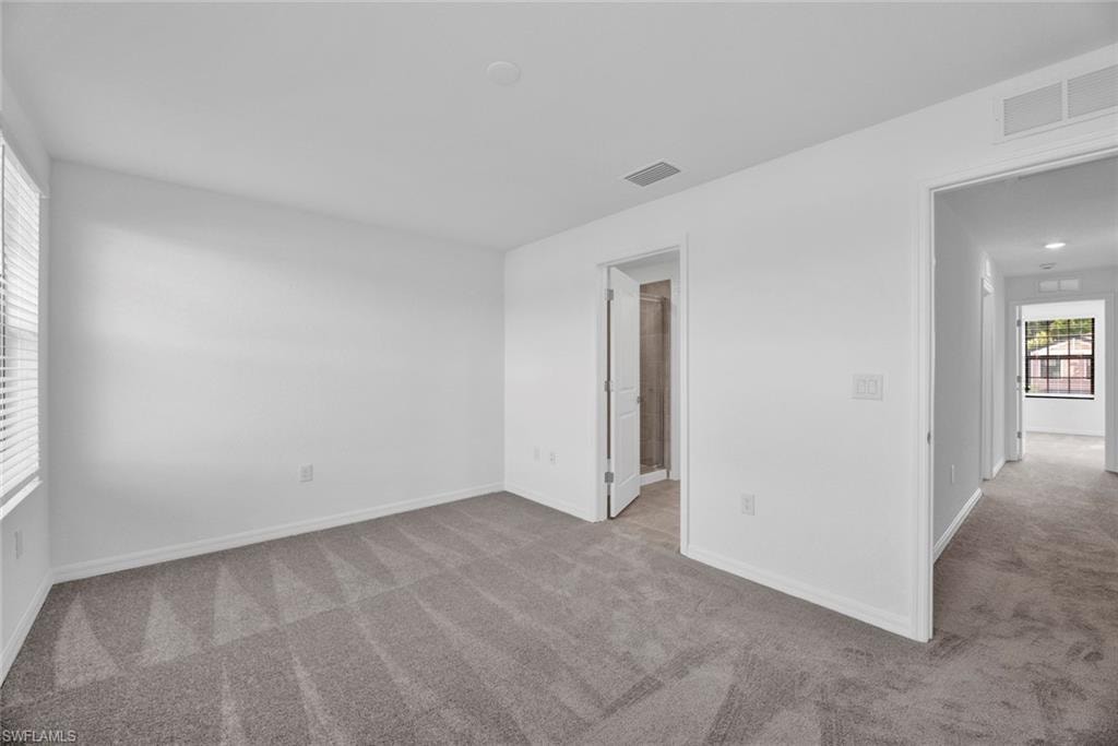 Unfurnished room featuring light carpet