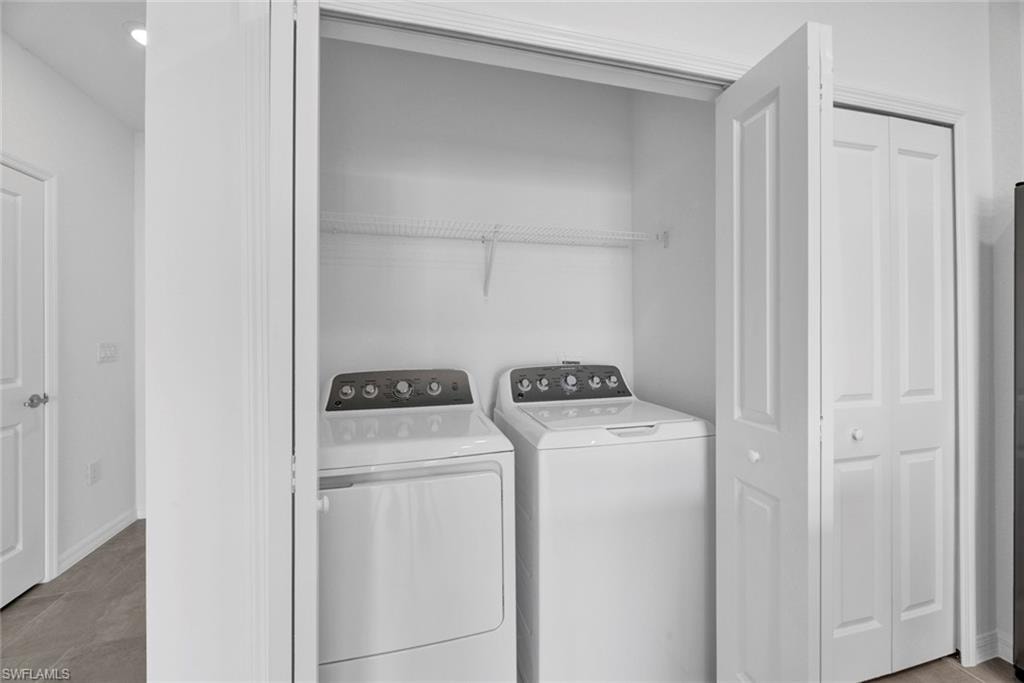 Washroom with baseboards and washer and dryer