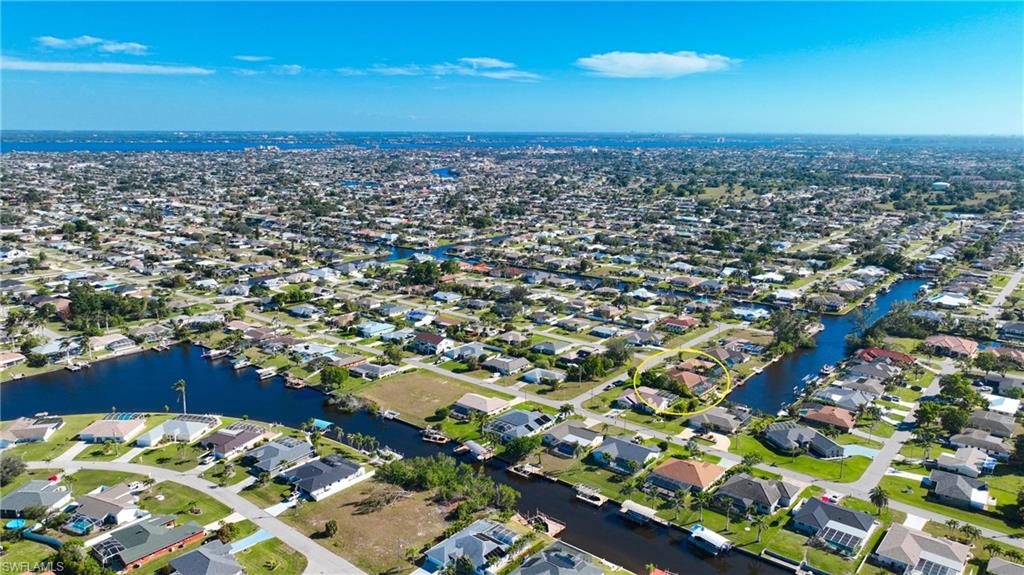 Aerial view of property's location with nearby suburban area and a large body of water