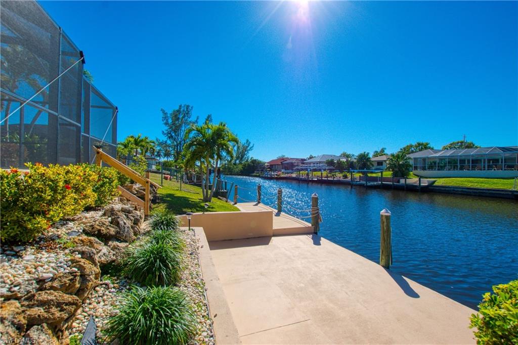 Dock area featuring a lanai, a sunroom, and a water view