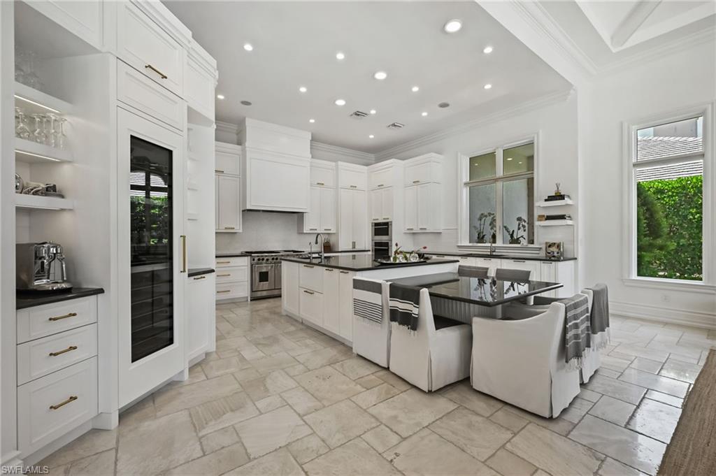 Kitchen with open shelves, crown molding, white cabinets, recessed lighting, and backsplash
