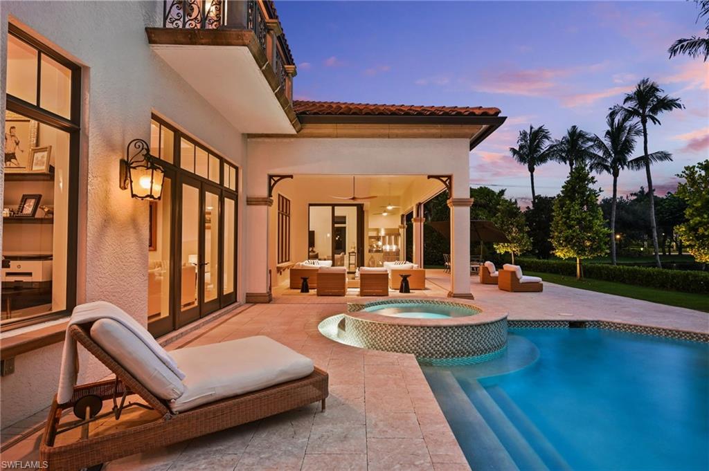 View of pool with a patio area, a pool with connected hot tub, an outdoor living space, and french doors