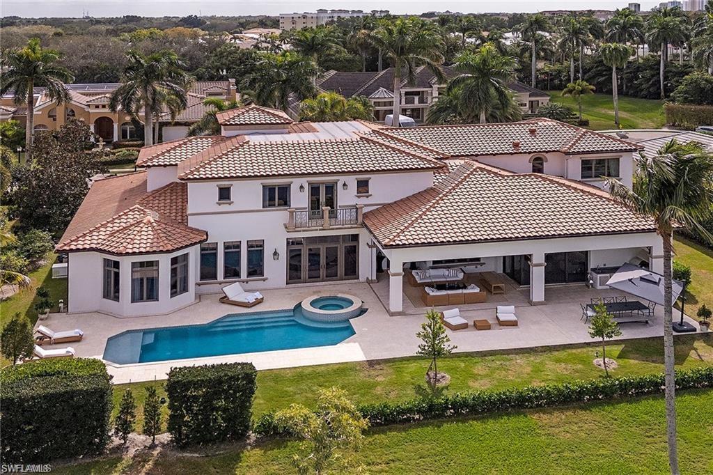 Back of property featuring a patio area, stucco siding, french doors, and a tile roof