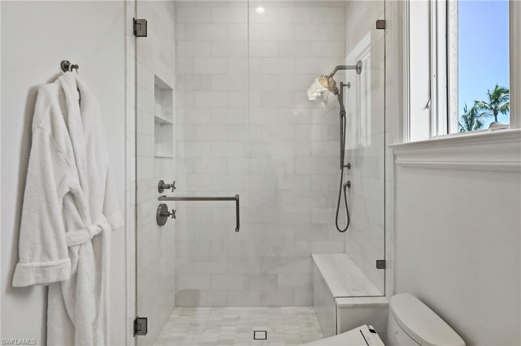 Full bath with a stall shower and toilet