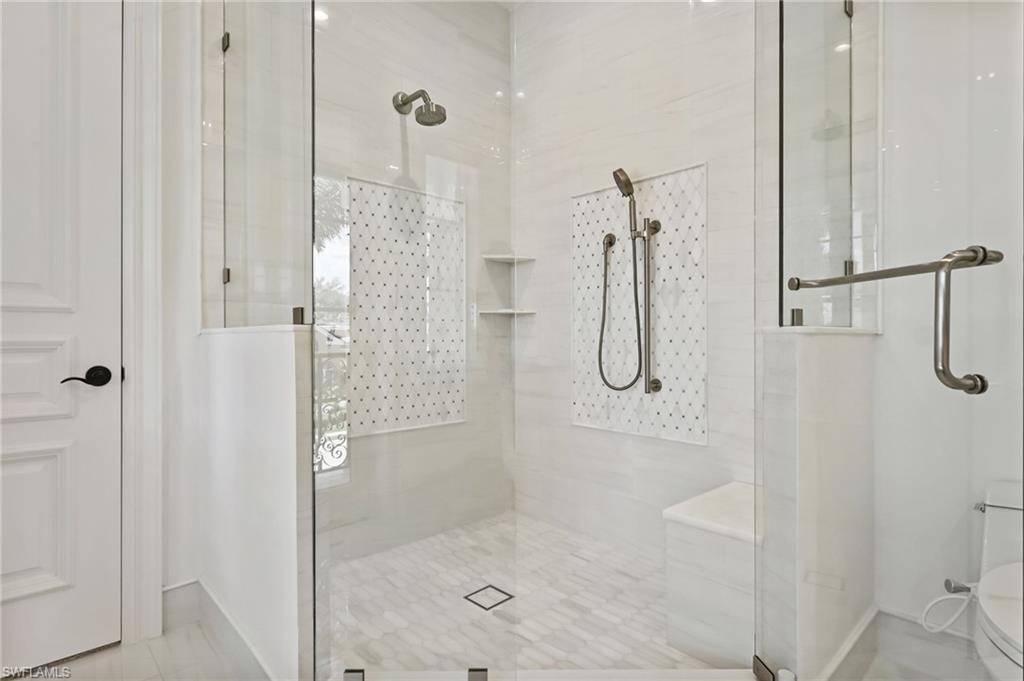 Full bathroom with a stall shower and tile patterned floors