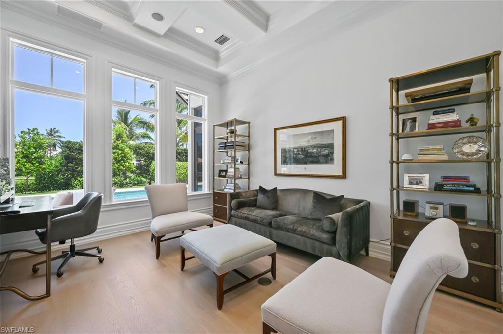 Office area featuring light wood-type flooring, crown molding, beamed ceiling, and coffered ceiling